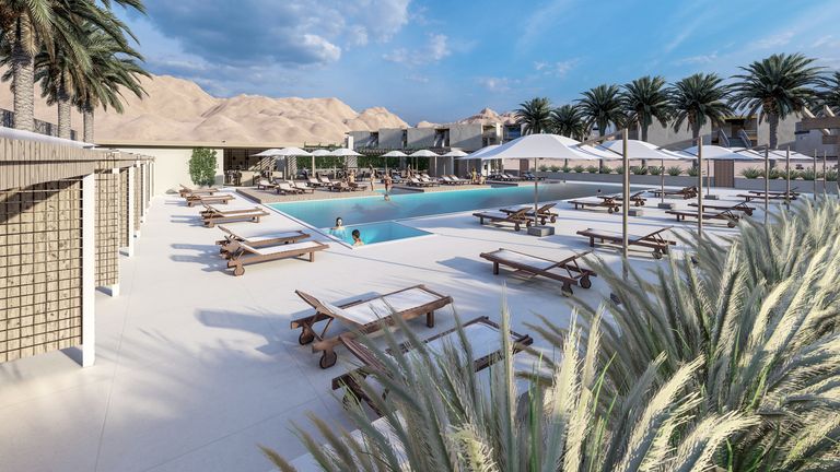 Rendering of the Civana Retreat pool area seen past the cabanas, with lounge chairs, umbrellas and desert grasses